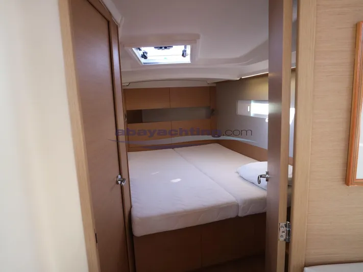  Yacht Photos Pics Cozy cabin interior of 2019 Jeanneau Sun Odyssey 410 sailboat with natural light.