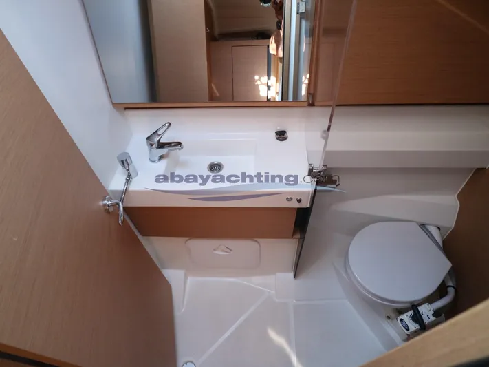  Yacht Photos Pics Bathroom interior of 2019 Jeanneau Sun Odyssey 410 yacht, featuring sink and toilet.