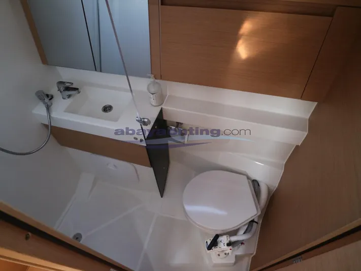  Yacht Photos Pics Bathroom interior of 2019 Jeanneau Sun Odyssey 410 yacht, featuring sink and toilet.
