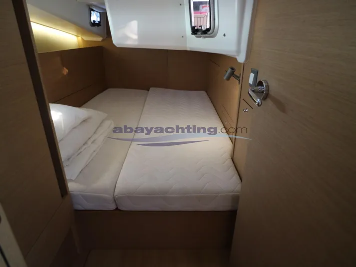  Yacht Photos Pics Cozy cabin interior of 2019 Jeanneau Sun Odyssey 410 yacht with comfortable bedding.