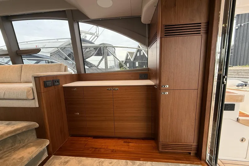 F50199 Yacht Photos Pics Luxurious interior of 2024 Princess F50 yacht with elegant wood cabinetry and plush seating.