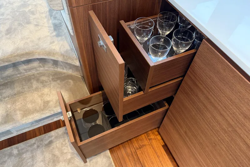 F50199 Yacht Photos Pics Luxury yacht interior with wooden drawers storing glassware, Princess F50 2024 model.