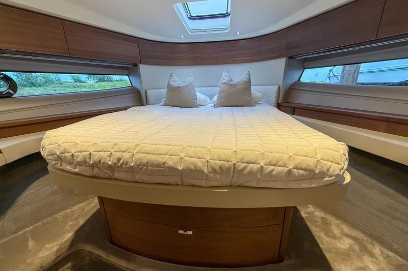 F50199 Yacht Photos Pics Luxurious interior of 2024 Princess F50 yacht with elegant bedding and wood accents.