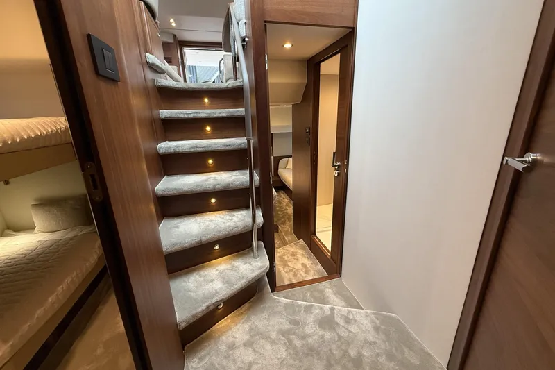 F50199 Yacht Photos Pics Luxurious interior of 2024 Princess F50 yacht with carpeted stairs and cozy cabin.