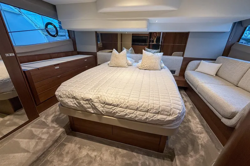 F50199 Yacht Photos Pics Luxurious 2024 Princess F50 yacht bedroom with elegant bedding and modern furnishings.