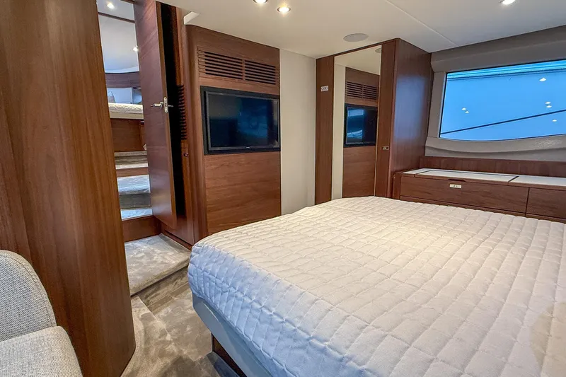 F50199 Yacht Photos Pics Luxurious 2024 Princess F50 yacht bedroom with modern wood finishes and large window.
