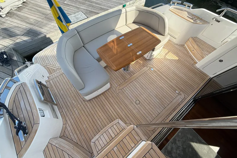F50199 Yacht Photos Pics Luxurious 2024 Princess F50 yacht deck with elegant seating and wooden table.