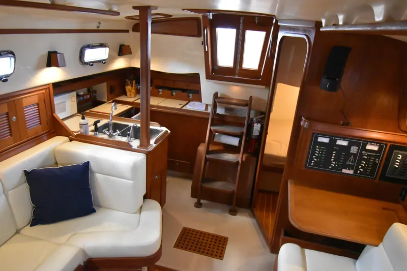 Promises Yacht Photos Pics Interior of 1998 Island Packet 350 sailboat with cozy seating and wooden cabinetry.