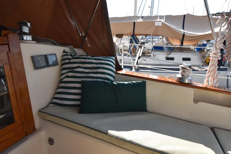 Promises Yacht Photos Pics Cozy seating area on 1998 Island Packet 350 sailboat with striped cushions and nautical decor.