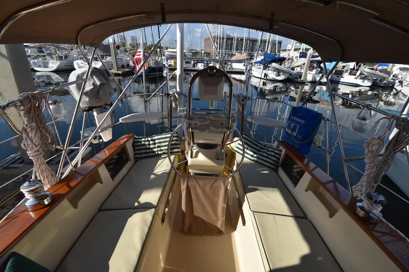 Promises Yacht Photos Pics Cockpit view of a 1998 Island Packet 350 sailboat docked at a marina.