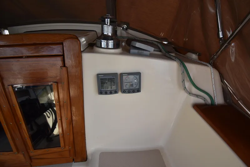 Promises Yacht Photos Pics 1998 Island Packet 350 sailboat cockpit with navigation instruments and wooden cabinetry.