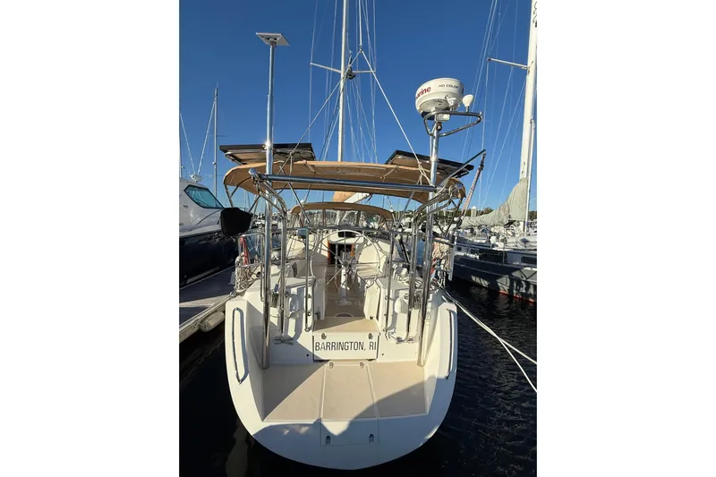 Pratique Yacht Photos Pics 2012 Outbound 46 sailboat docked in marina, rear view with clear blue sky.
