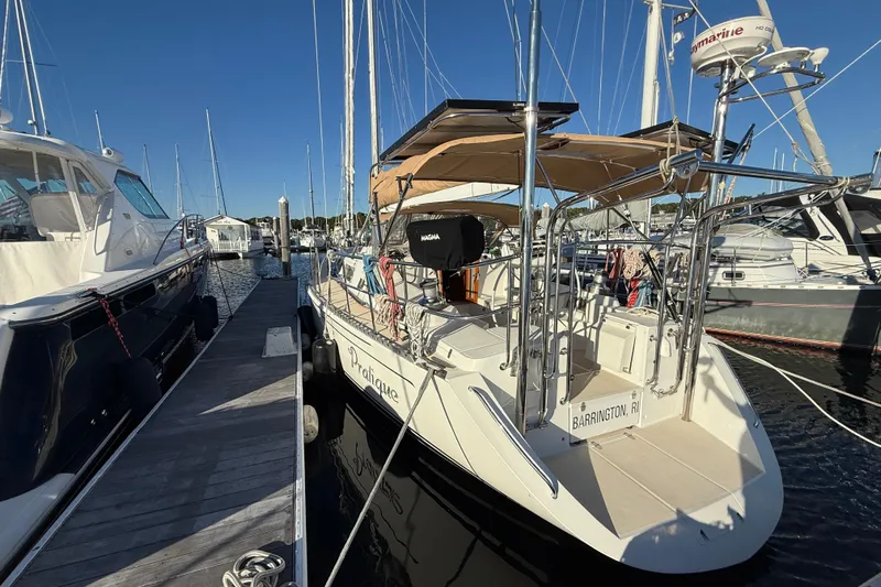 Pratique Yacht Photos Pics 2012 Outbound 46 sailboat docked in marina, Barrington, RI, with clear blue sky.
