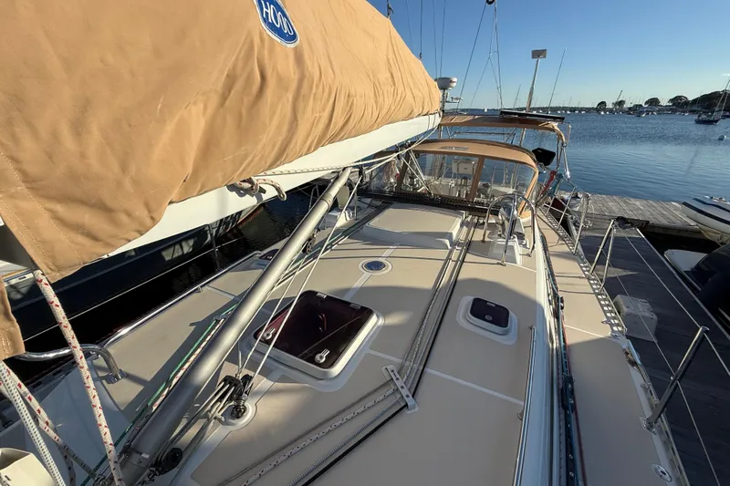 Pratique Yacht Photos Pics Sailboat docked at marina, Outbound 46 model, 2012, with tan sail cover.