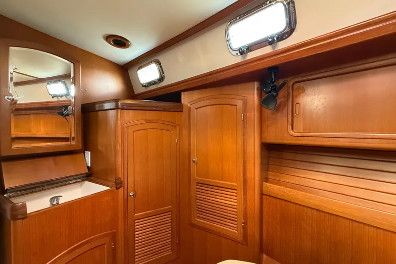 Pratique Yacht Photos Pics Luxurious wooden interior of 2012 Outbound 46 yacht bathroom with mirror and storage.