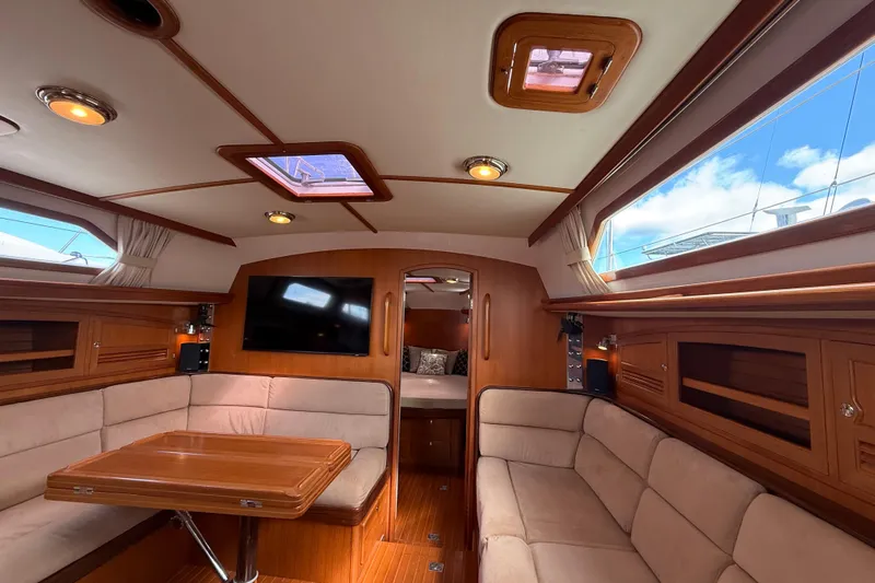 Pratique Yacht Photos Pics Luxurious interior of 2012 Outbound 46 yacht with plush seating and wooden finishes.