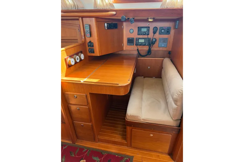 Pratique Yacht Photos Pics Luxurious 2012 Outbound 46 yacht interior with navigation station and wooden cabinetry.