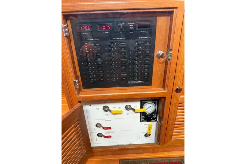 Pratique Yacht Photos Pics Electrical control panel on a 2012 Outbound 46 yacht, featuring AC and DC systems.