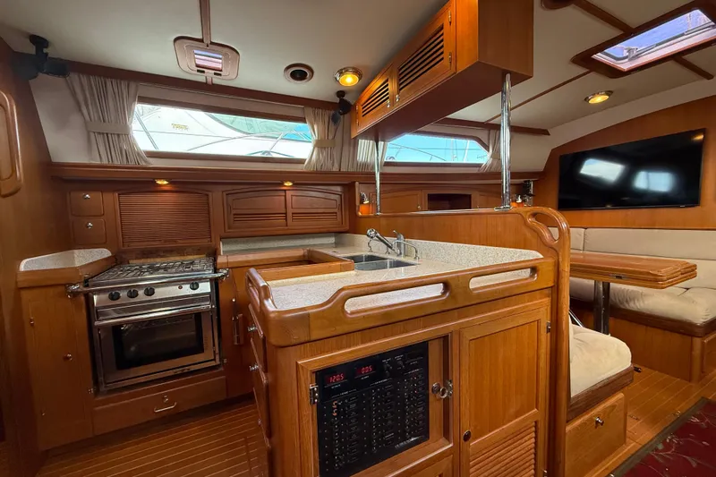 Pratique Yacht Photos Pics Luxurious 2012 Outbound 46 yacht interior with kitchen, dining area, and modern amenities.
