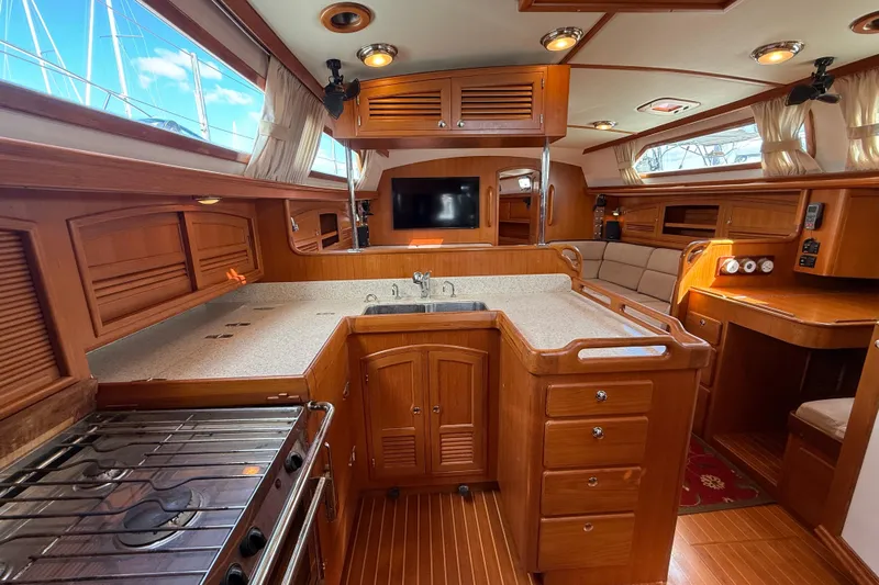 Pratique Yacht Photos Pics Luxurious 2012 Outbound 46 yacht interior with wooden cabinetry and modern amenities.