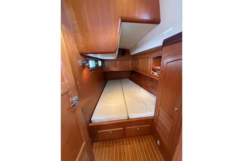 Pratique Yacht Photos Pics Luxurious wooden cabin interior of 2012 Outbound 46 yacht with cozy bed.