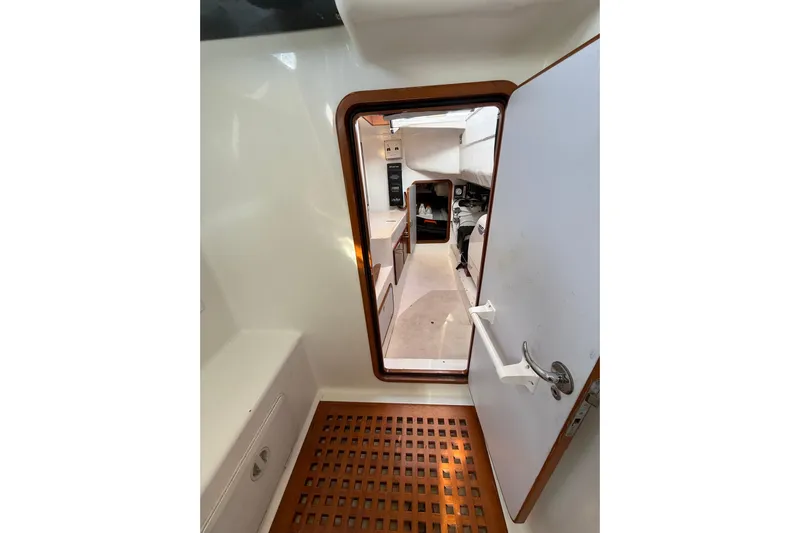 Pratique Yacht Photos Pics Interior view of 2012 Outbound 46 sailboat, featuring cabin entrance and wooden flooring.