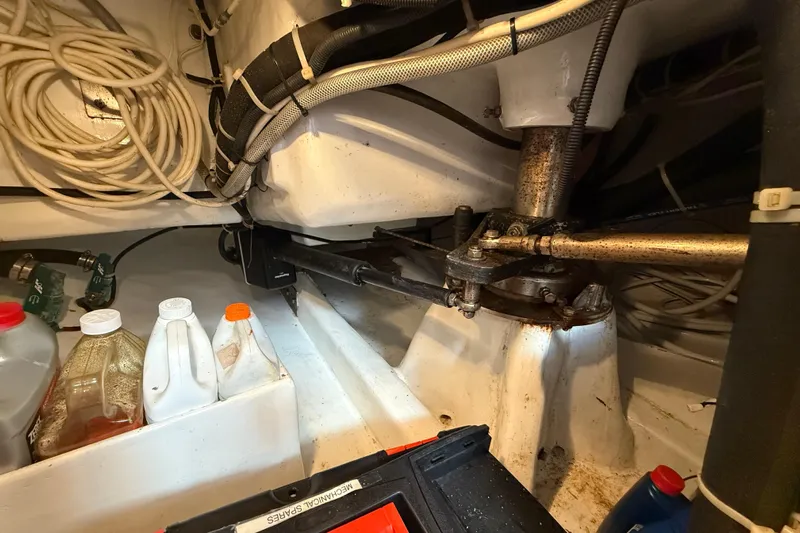 Pratique Yacht Photos Pics Engine room of 2012 Outbound 46 sailboat with mechanical components and storage containers.