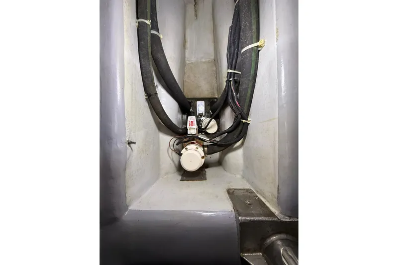 Pratique Yacht Photos Pics Engine compartment of 2012 Outbound 46 sailboat with visible hoses and components.