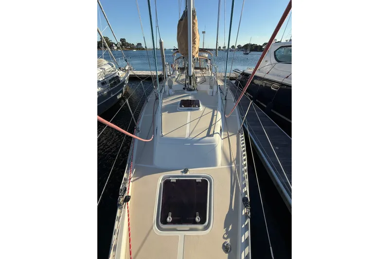 Pratique Yacht Photos Pics Sailboat docked at marina, Outbound 46 model, 2012, with clear sky and calm water.