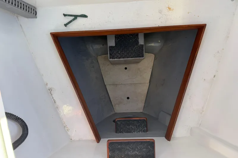 Pratique Yacht Photos Pics Interior view of 2012 Outbound 46 sailboat with steps and wooden trim.