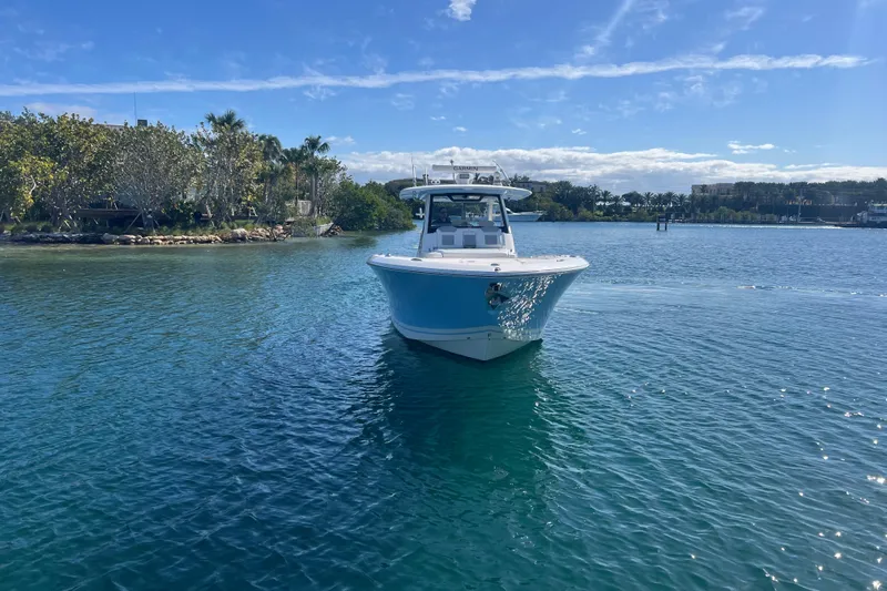  Yacht Photos Pics 2019 Pursuit S 368 Sport boat on clear blue water under a sunny sky.