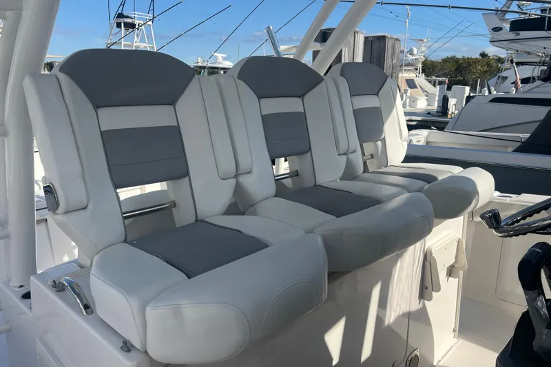  Yacht Photos Pics 2019 Pursuit S 368 Sport boat seats, gray and white upholstery, docked at marina.