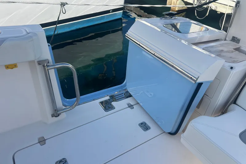  Yacht Photos Pics 2019 Pursuit S 368 Sport boat interior with open hatch and water view.
