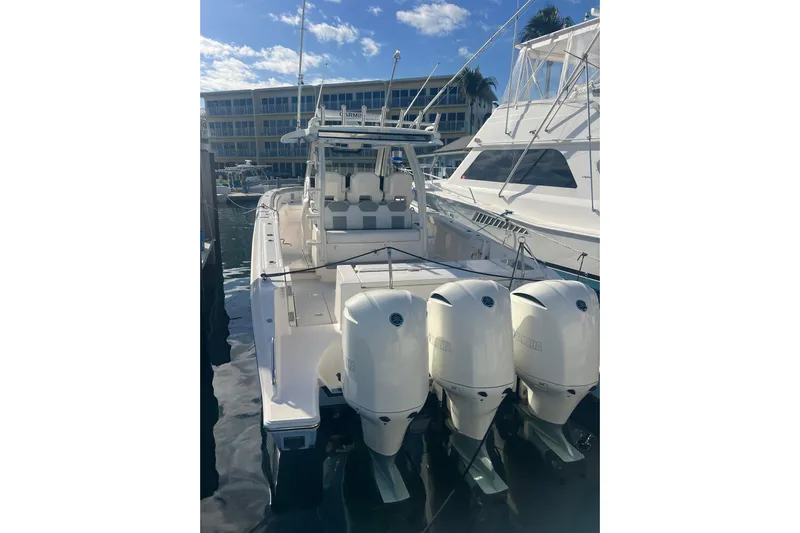  Yacht Photos Pics 2019 Pursuit S 368 Sport boat with triple outboard engines docked at marina.