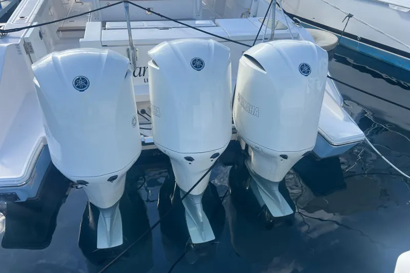  Yacht Photos Pics 2019 Pursuit S 368 Sport with triple Yamaha outboard engines docked in marina.