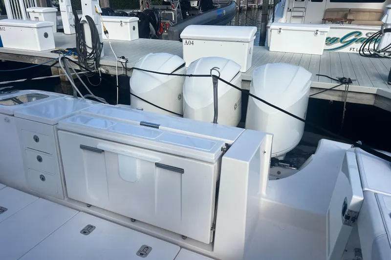  Yacht Photos Pics 2019 Pursuit S 368 Sport boat with triple outboard engines docked at marina.