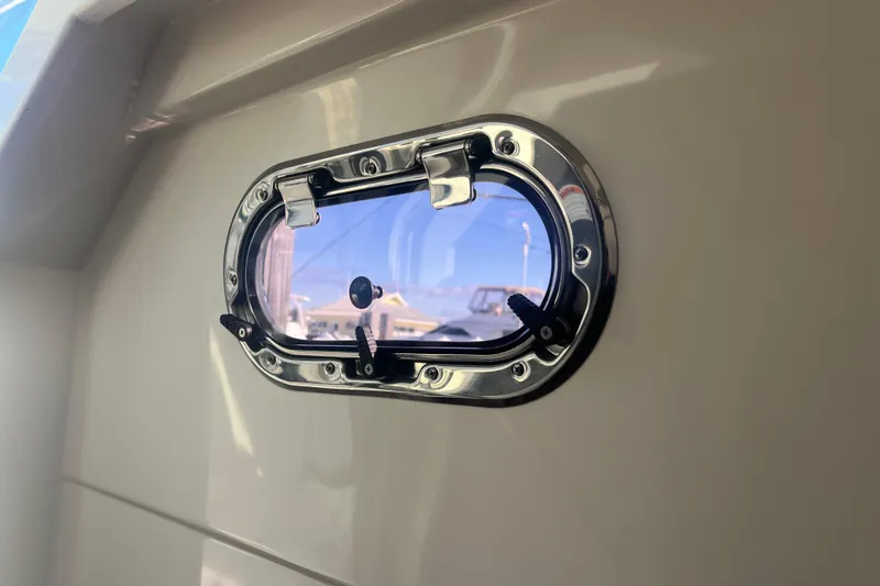  Yacht Photos Pics 2019 Pursuit S 368 Sport boat porthole with chrome finish and clear view.