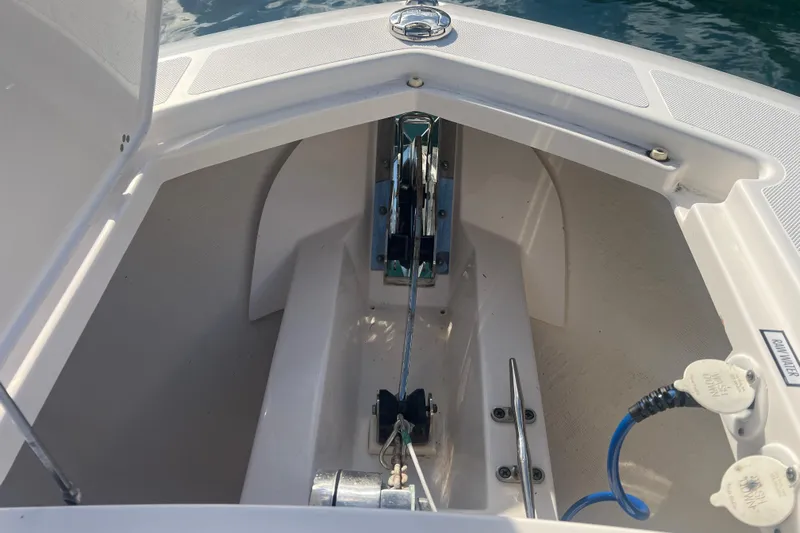  Yacht Photos Pics 2019 Pursuit S 368 Sport boat anchor compartment with marine equipment.
