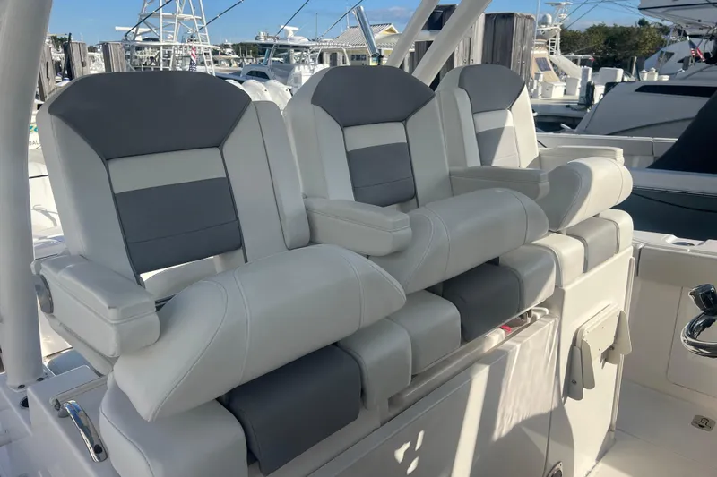  Yacht Photos Pics 2019 Pursuit S 368 Sport boat seats, gray and white, in a marina setting.