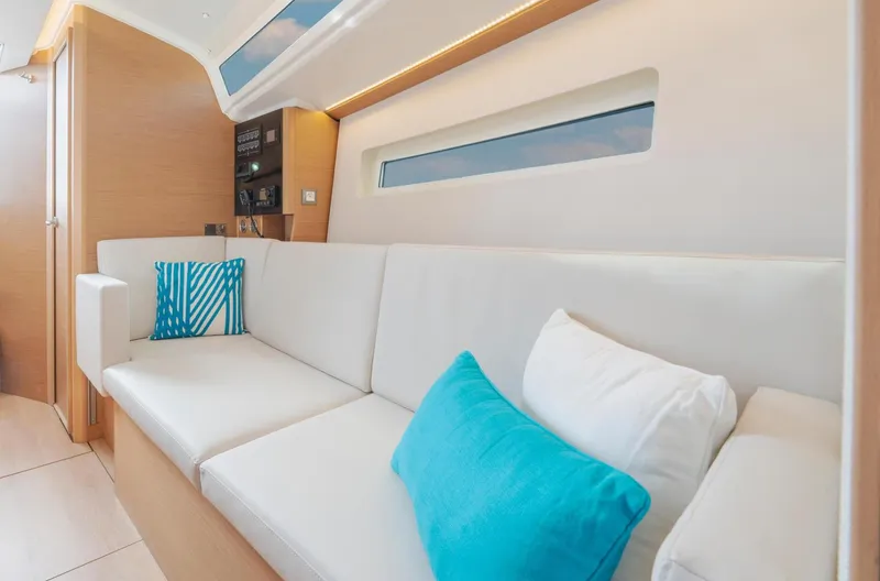  Yacht Photos Pics Interior of 2026 Jeanneau Sun Odyssey 350 yacht with modern white and blue seating.