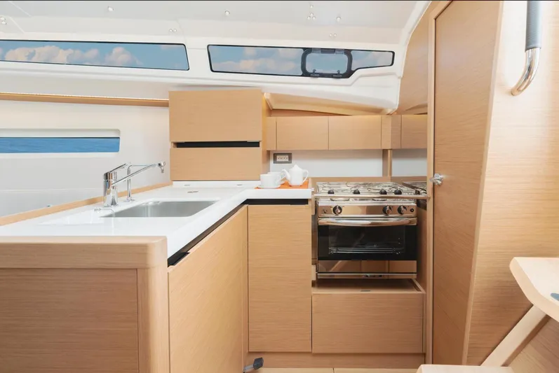  Yacht Photos Pics Modern kitchen interior of 2026 Jeanneau Sun Odyssey 350 yacht with sleek design and appliances.