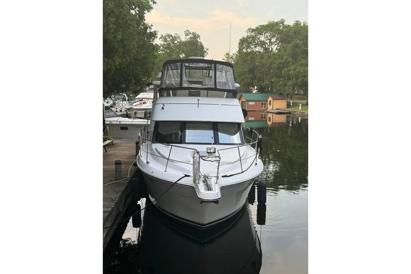  Yacht Photos Pics 2000 Carver 404 Cockpit Motor Yacht docked by a serene lakeside.