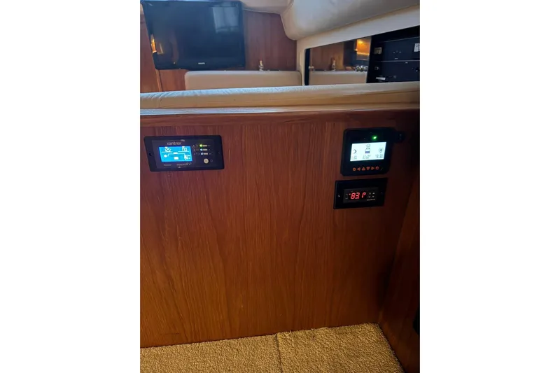  Yacht Photos Pics Control panel inside 2000 Carver 404 Cockpit Motor Yacht, featuring digital displays and wood finish.