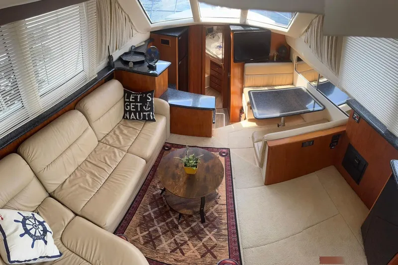  Yacht Photos Pics Luxurious interior of 2000 Carver 404 Cockpit Motor Yacht with plush seating and dining area.