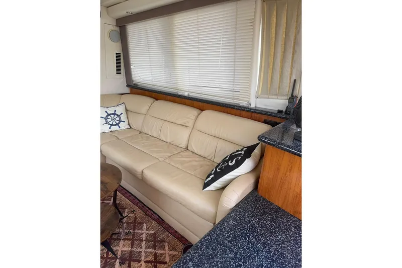  Yacht Photos Pics Interior of 2000 Carver 404 Cockpit Motor Yacht with beige leather sofa and nautical decor.