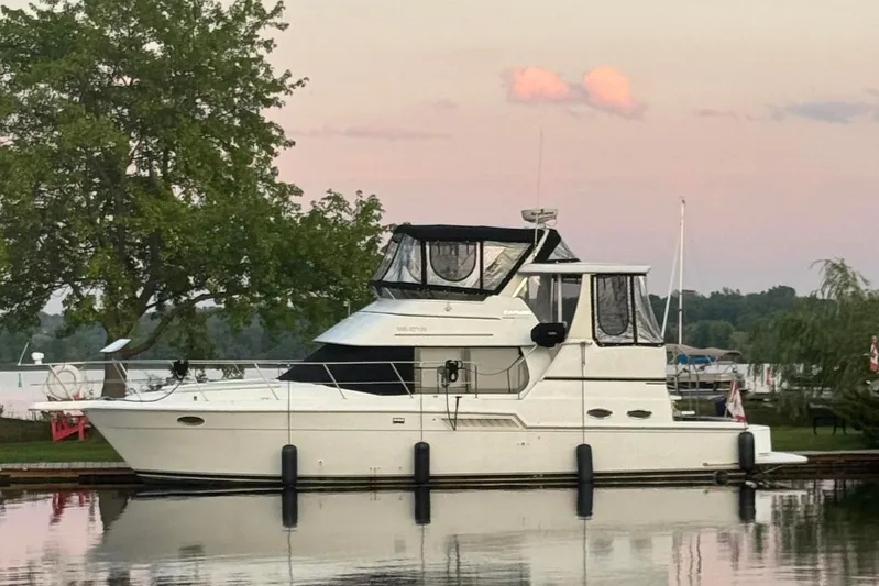  Yacht Photos Pics 2000 Carver 404 Cockpit Motor Yacht docked at sunset, reflecting on calm water.