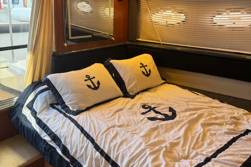  Yacht Photos Pics Cozy bedroom in 2000 Carver 404 Cockpit Motor Yacht with nautical-themed bedding.