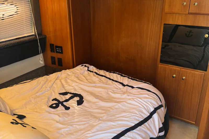  Yacht Photos Pics Interior cabin of 2000 Carver 404 Cockpit Motor Yacht with nautical-themed bedding.