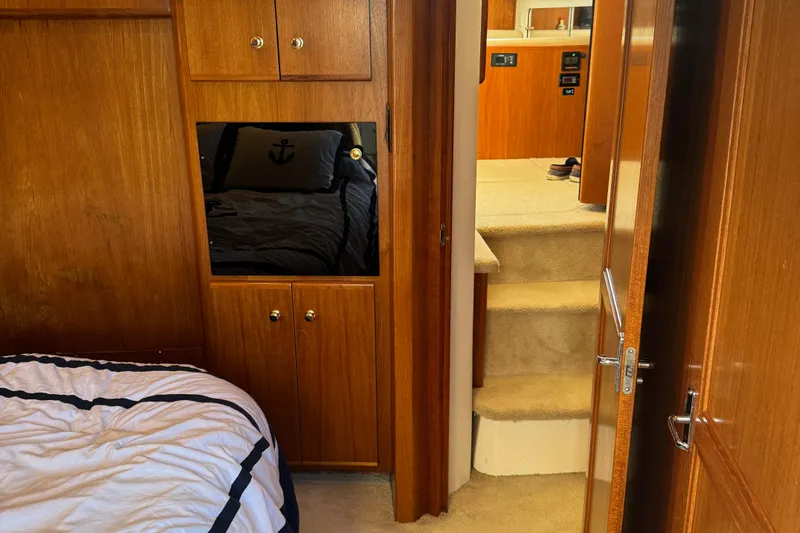  Yacht Photos Pics Interior of 2000 Carver 404 Cockpit Motor Yacht with wood paneling and cozy bedding.