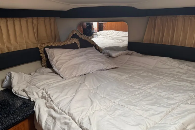  Yacht Photos Pics Cozy bedroom interior of 2000 Carver 404 Cockpit Motor Yacht with plush bedding.